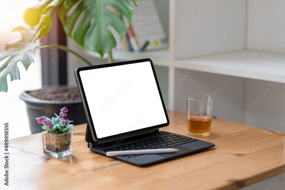Fototapeta premium Tablet blank screen on desk and workspace background in modern office.