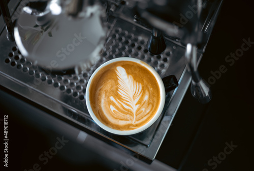 Leinwand Poster portafilter barista cup of coffee with creamy cappuccino latte art
