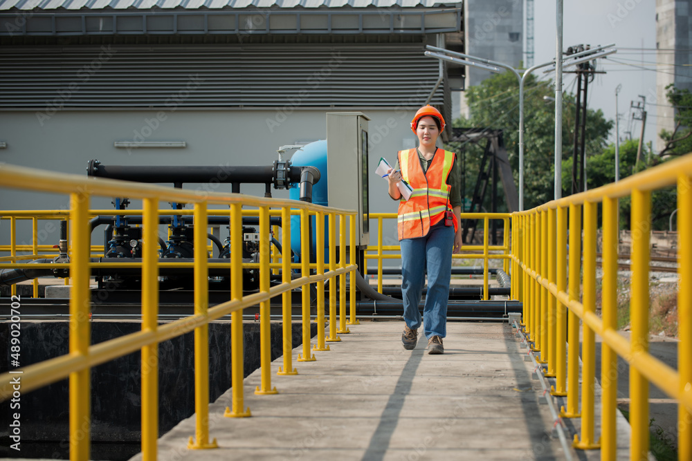 Engineer woman onsite check waste water treatment plant. Young woman