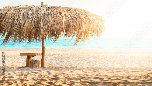 palapa sun roof beach umbrella in caribbean photo