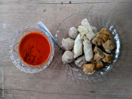 meatball with tomato sauce. close-up shot. wood background. photo