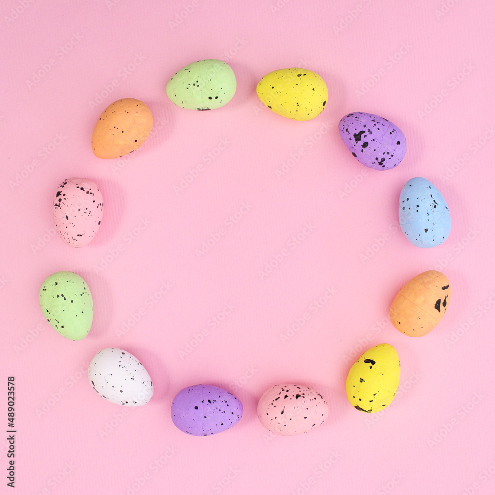 Creative circle copy space frame for Easter made with eggs on pastel pink background. Flat lay minimal.
