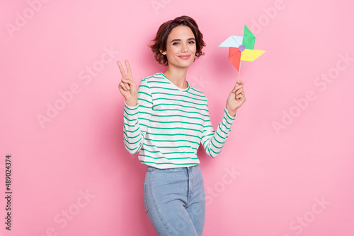Photo of cool millennial bob hairdo lady play game show v-sign wear striped shirt isolated on pink color background