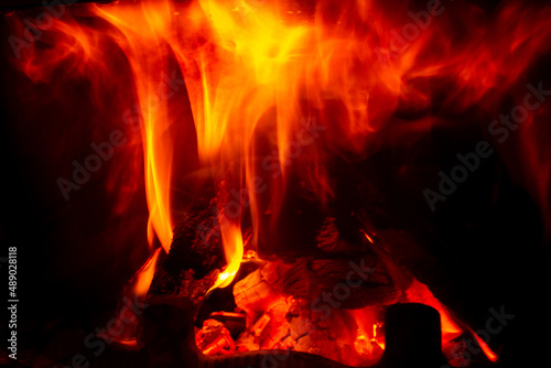 Burning wood in a home fireplace, red flames