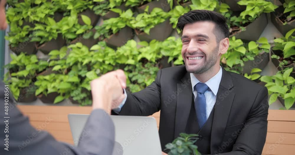 Two business people financial partners confirm the transaction with a handshake. Business people meet at coffee shop and restaurant. Two business people financial partners confirm the transaction with a handshake. Business people meet at coffee shop and restaurant.