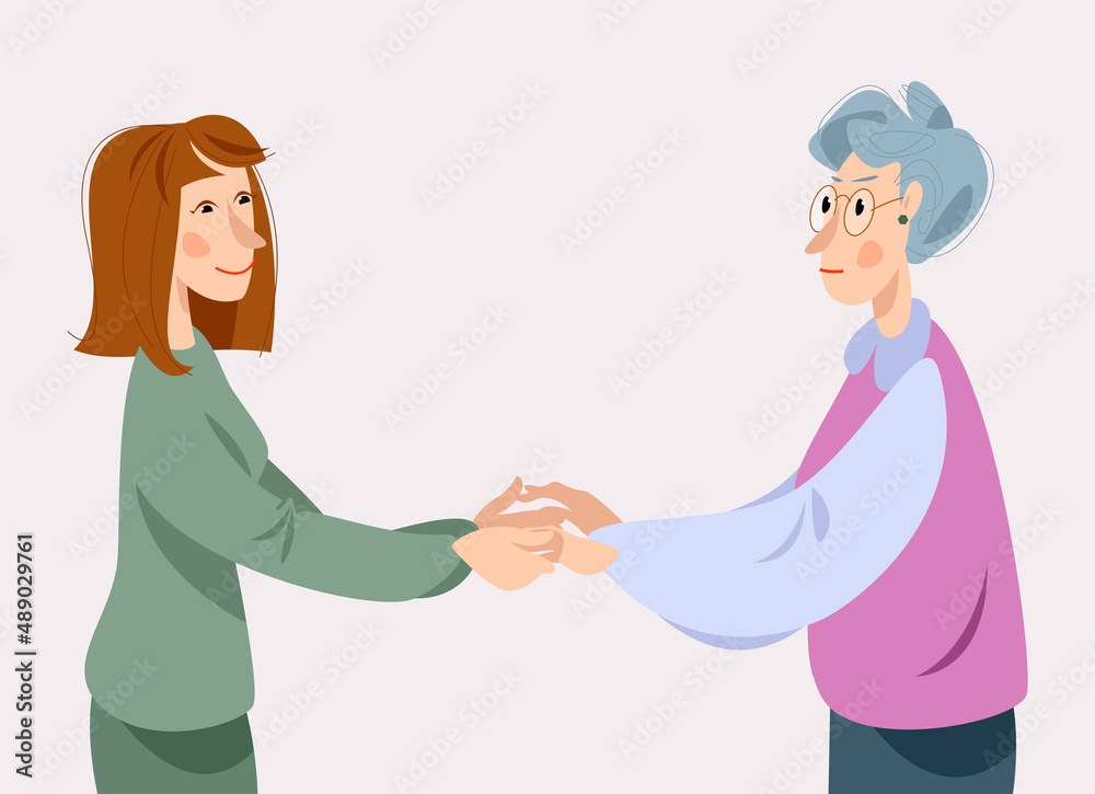 Young and elderly women holding hands and looking at each other. Dementia awareness. Young and elderly women holding hands and looking at each other. Dementia awareness.