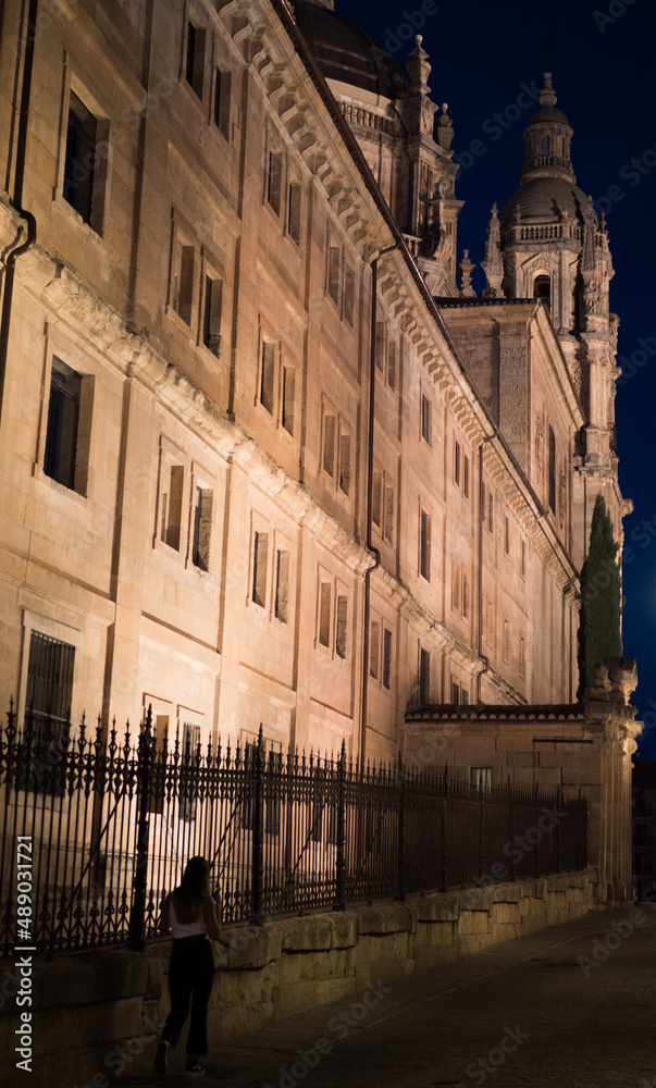 Tourist walking at night through the city of Salamanca
