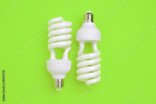 Fluorescent Lightbulbs on a green background. Energy saving concept, alternative energy sources, idea