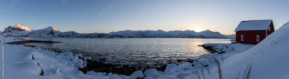panoramic view sunset in Skaland on island Senja in northern Norway in winter