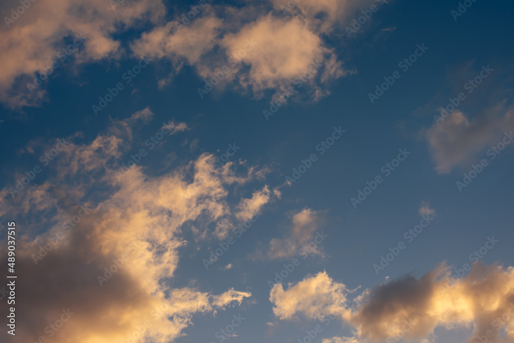 pastel clouds against a blue sky at sunset