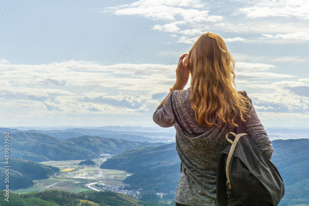 Woman enjoying the views from the top of Mt Kogaisan, in a rural area in the Miyagi Prefecture, Japan