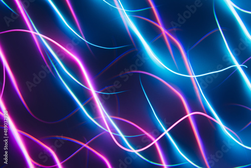 Neon blue and pink led lines on a dark night background. Kaleidoscope futuristic backdrop. photo
