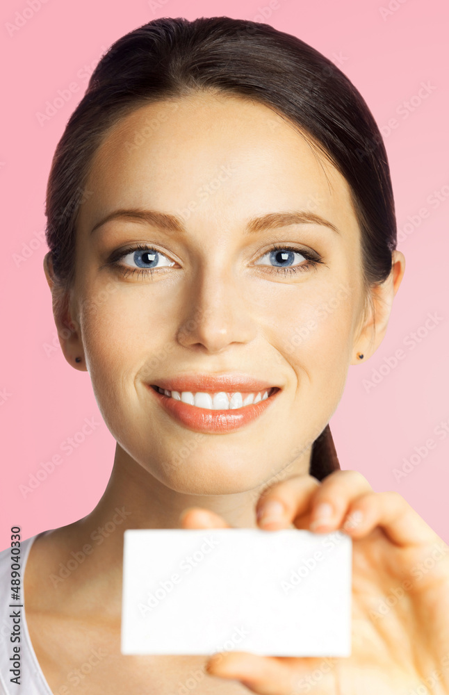 Closeup portrait of smiling businesswoman showing mockup empty businesscard or plastic credit card, with copy space, over rose pink background. Brunette business woman at studio image. Closeup portrait of smiling businesswoman showing mockup empty businesscard or plastic credit card, with copy space, over rose pink background. Brunette business woman at studio image.