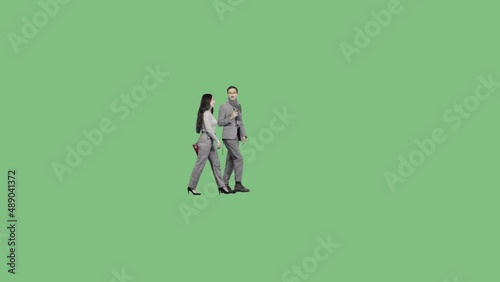 A young man and a woman walk together and talk. Green screen clip with alpha channel