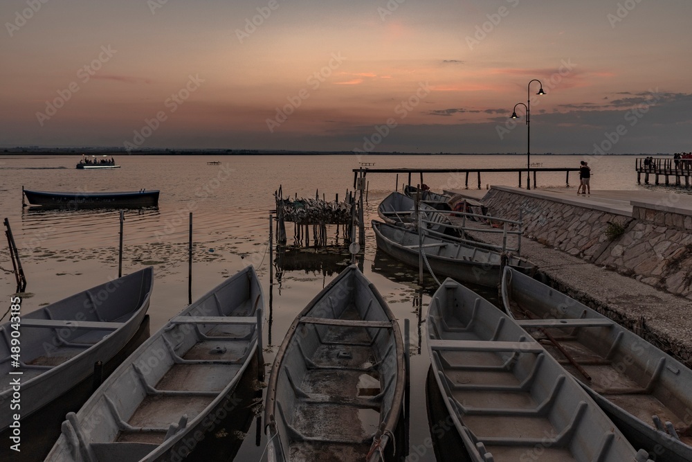 Fototapeta premium Beautiful background with boats in the lake at sunset