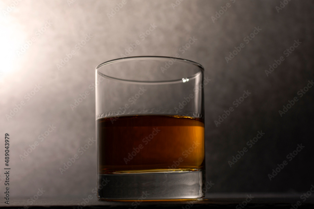 glass goblet with whiskey on a dark background glass goblet with whiskey on a dark background
