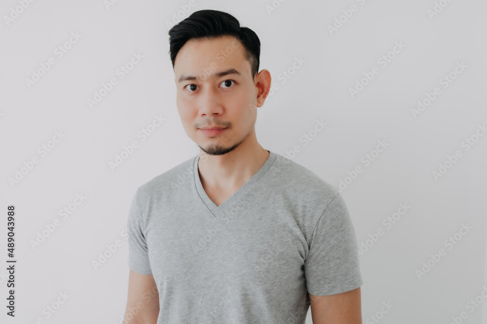 Fototapeta premium Portrait of smile Asian man wear grey t-shirt isolated on white wall.