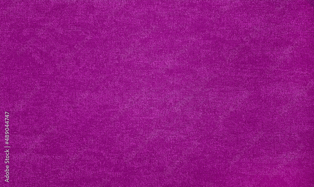 Fototapeta premium textured background surface of pink textile upholstery wallpaper in close-up view. pink color fabric structure detail. macro of a woolen cloth texture.