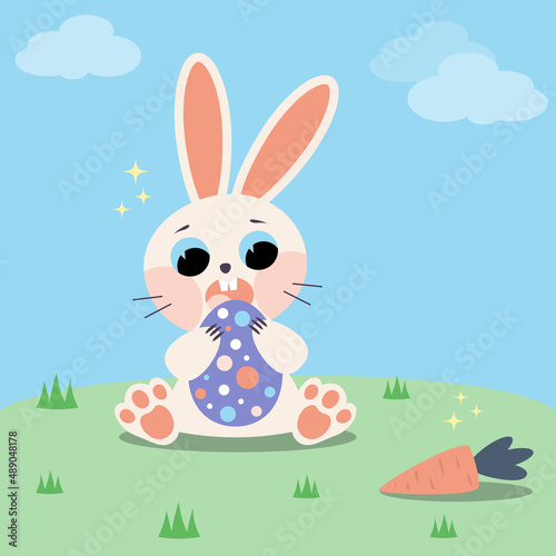 Cute rabbit on the lawn with an Easter egg. A postcard for the Easter holiday.