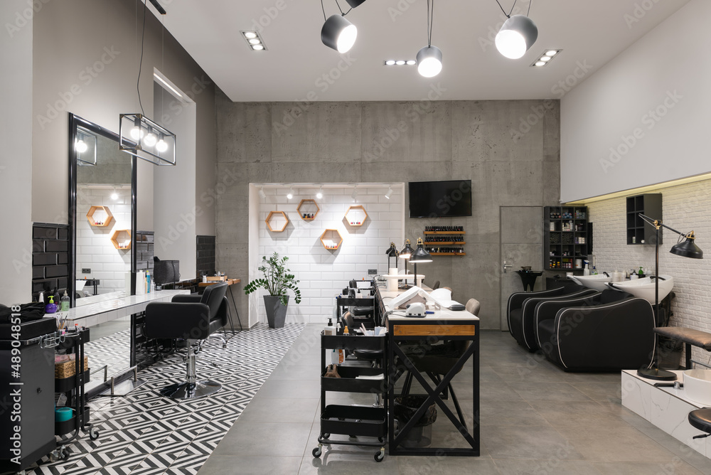Modern interior of the beauty salon which consist of nail salon and barbershop.