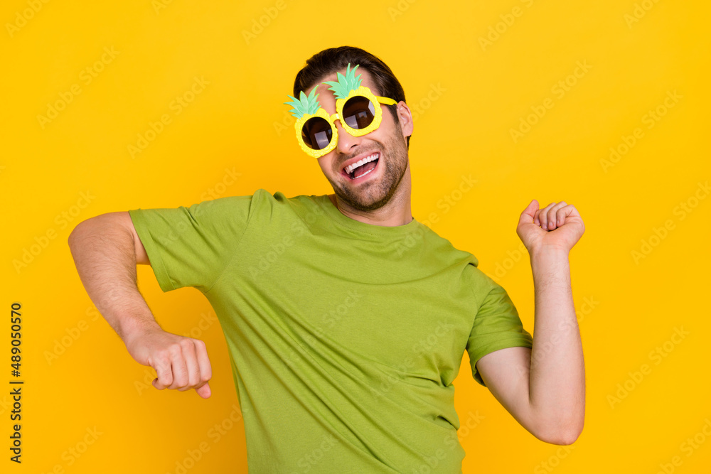 Photo of young cheerful guy good mood dance club vacation chill rest isolated over yellow color background Photo of young cheerful guy good mood dance club vacation chill rest isolated over yellow color background