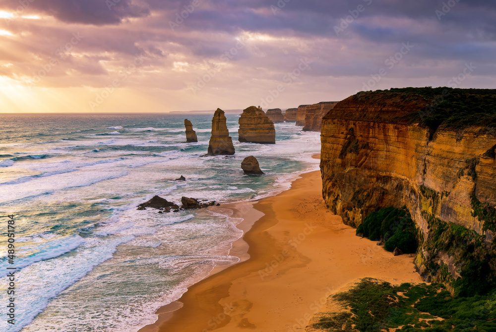 Sunset over Twelves Apostles in Great Ocean Road, Victoria, Australia. The Twelve Apostles is a collection of limestone stacks off the shore of the Port Campbell National Park.