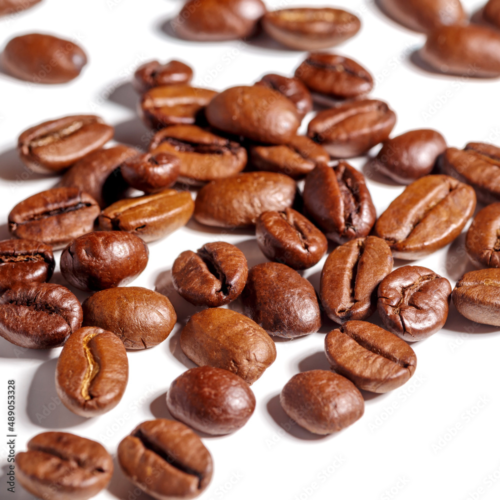 Heap of fresh roasted coffee beans isolated on white background as package design elements Heap of fresh roasted coffee beans isolated on white background as package design elements