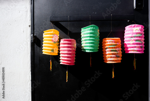 Lantern on black metal door with shadow