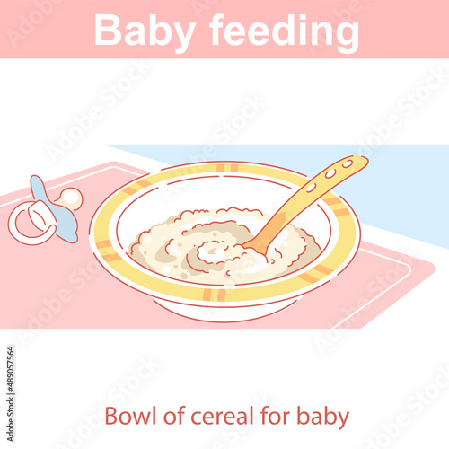 Baby feeding. Plate of cereal, puree on table.