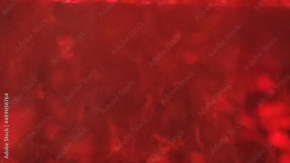 Boiling water bubbles illuminated by red light. Boiling water bubbles illuminated by red light.