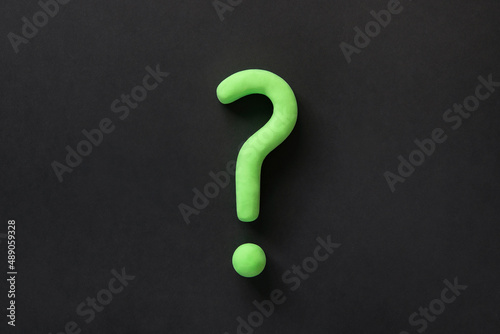 Green question mark on black background. 3d model, mock-up of interrogation point. Asking for important  information, dispute, hesitation concept.
