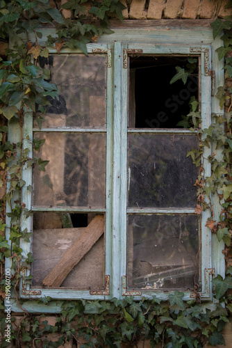 Sunja, Croatia, 05,04,2021: Rustic style aged window in wooden village rural home wall. © A1