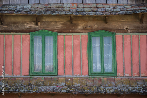 Sunja, Croatia, 05,04,2021: Rustic style aged window in wooden village rural home wall.