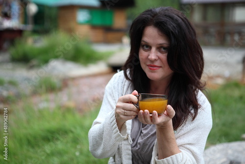 Woman in a cafe drinking sea buckthorn tea