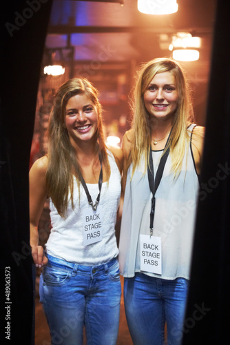 Two young women with backstage passes at a concert Fototapeta