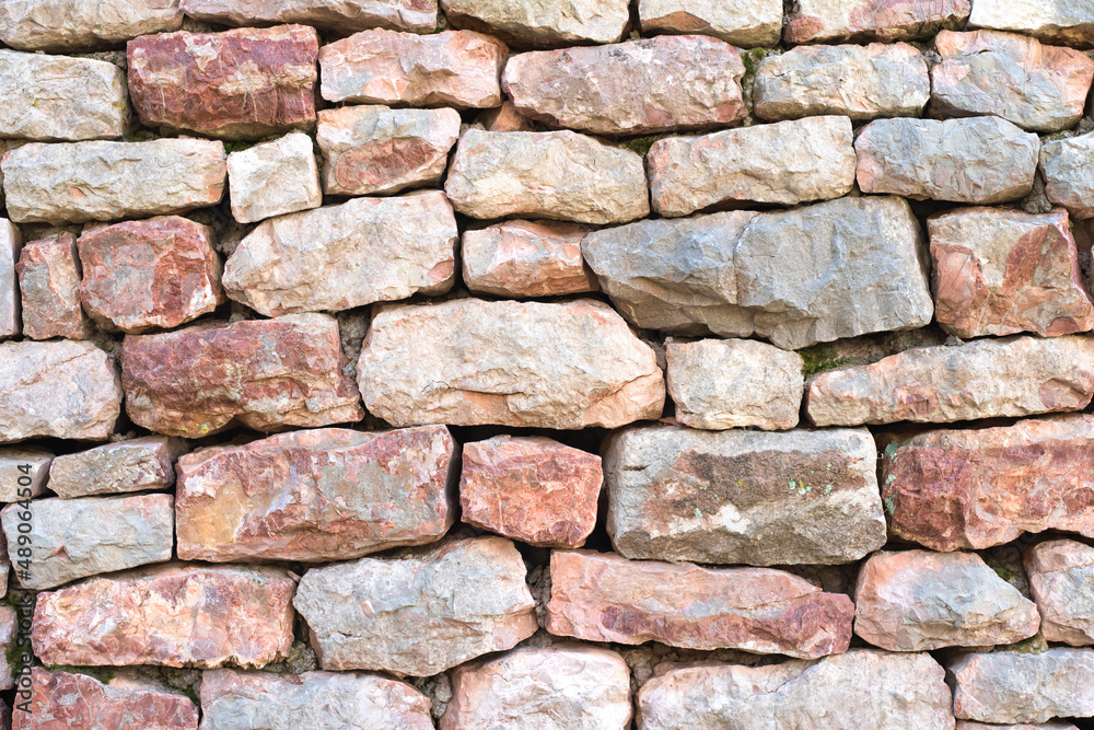 Texture of a stone wall. Natural and abstract background. Part of a building wall. Background for design. Texture of a stone wall. Natural and abstract background. Part of a building wall. Background for design.