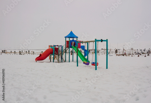 playground in the park with snow