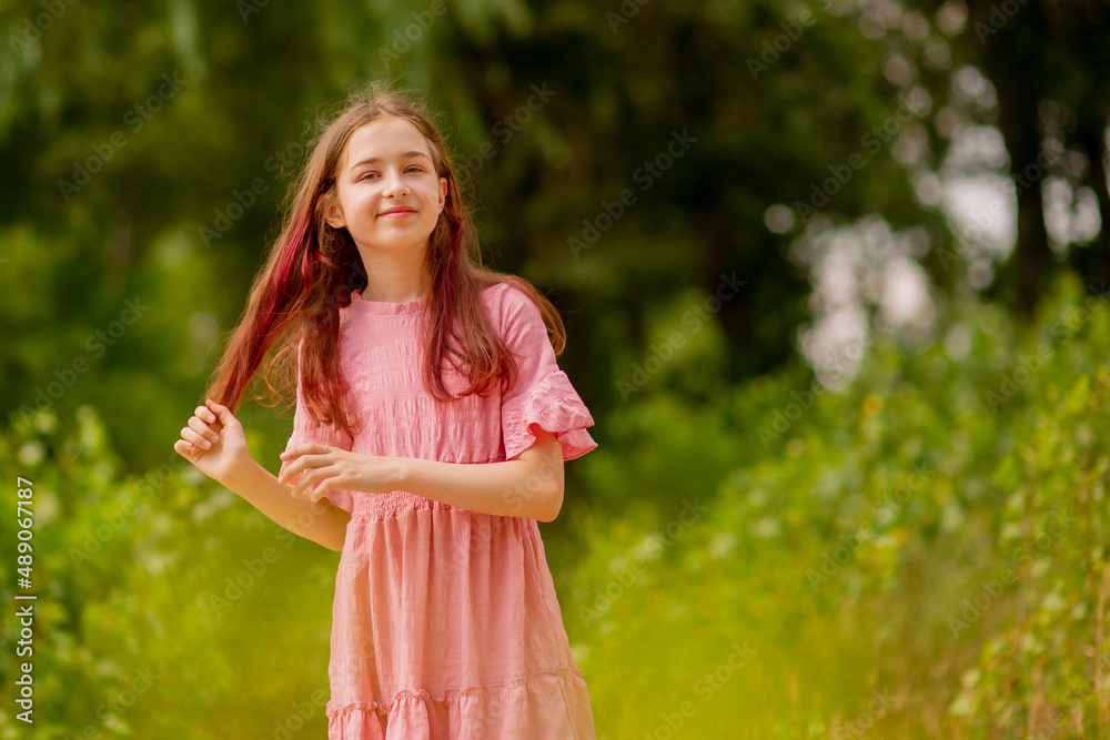 Beautiful teen girl. Girl 10 years old in a pink dress on a sunny summer day. Beautiful teen girl. Girl 10 years old in a pink dress on a sunny summer day.