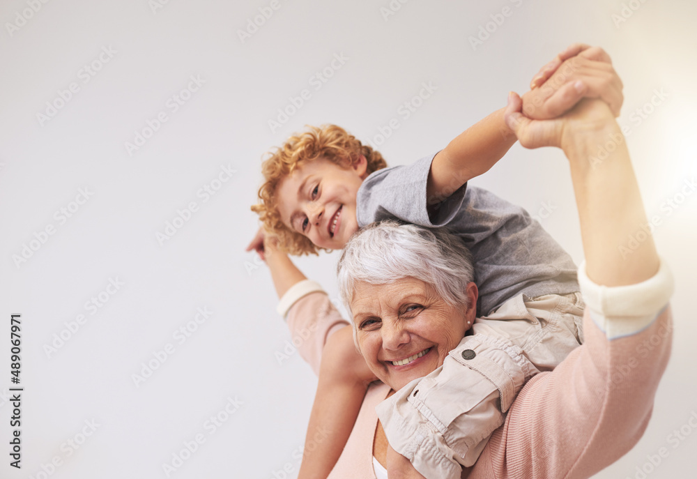 I have the best granny in the whole wide world. Shot of a grandmother giving her grandson a piggyback ride. - obrazy, fototapety, plakaty 