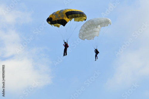 Athletes skydivers in the blue sky