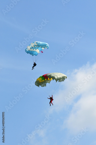 Athletes skydivers in the blue sky