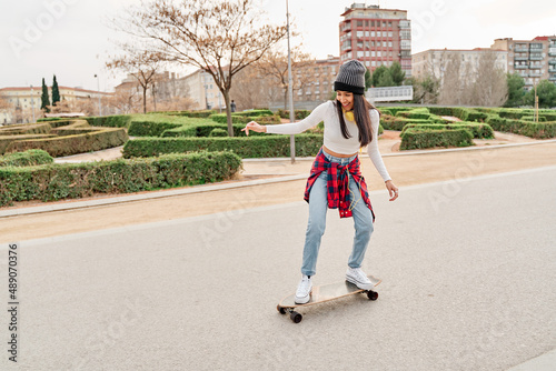 Young athlete riding a skateboard on the road. leisure and sport concept
