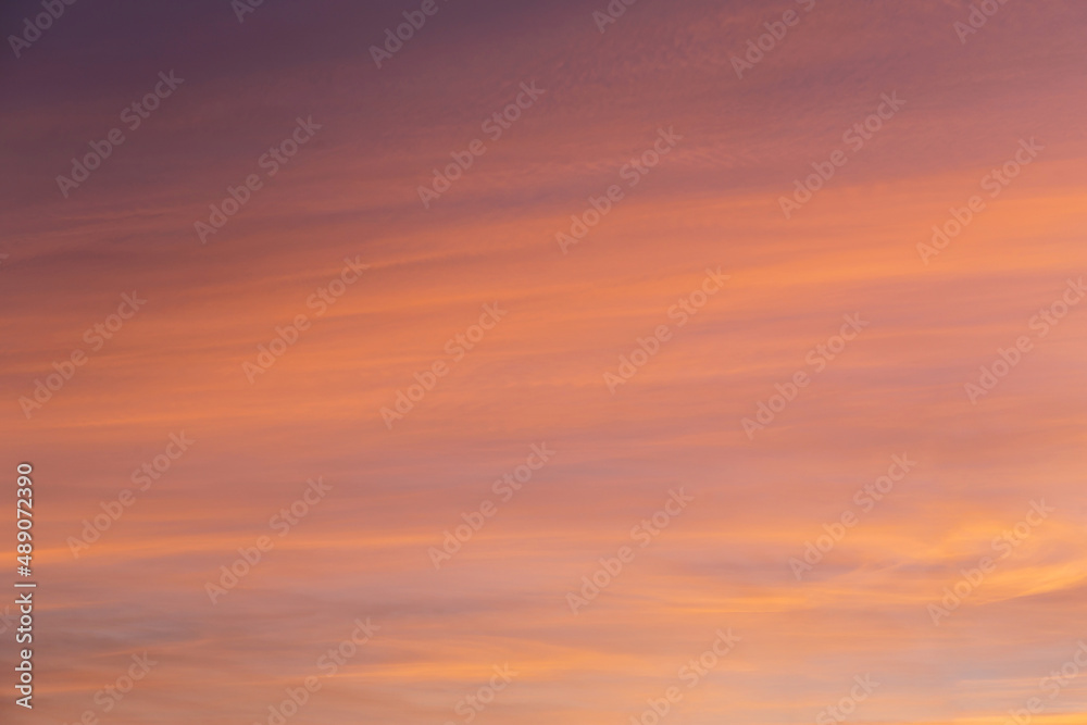 Beautiful soft sunrise, sunset yellow orange blue sky with cirrus clouds abstract background texture
