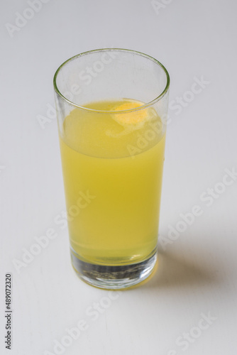Fruit vitamin fizzy drink in a transparent glass.