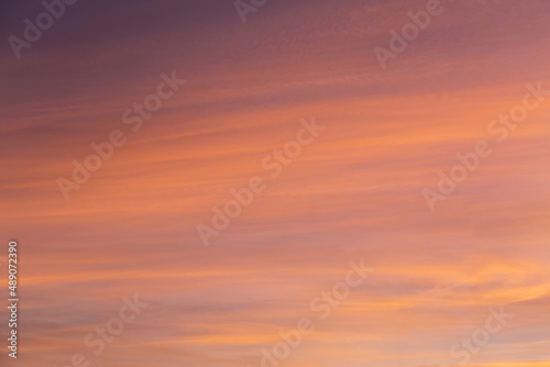 Beautiful soft sunrise, sunset yellow orange blue sky with cirrus clouds abstract background texture