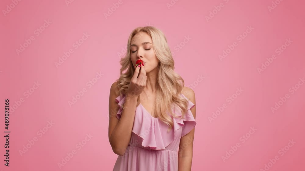 Pretty Blonde Lady Eating Strawberry Smiling Posing Over Pink Background Pretty Blonde Lady Eating Strawberry Smiling Posing Over Pink Background