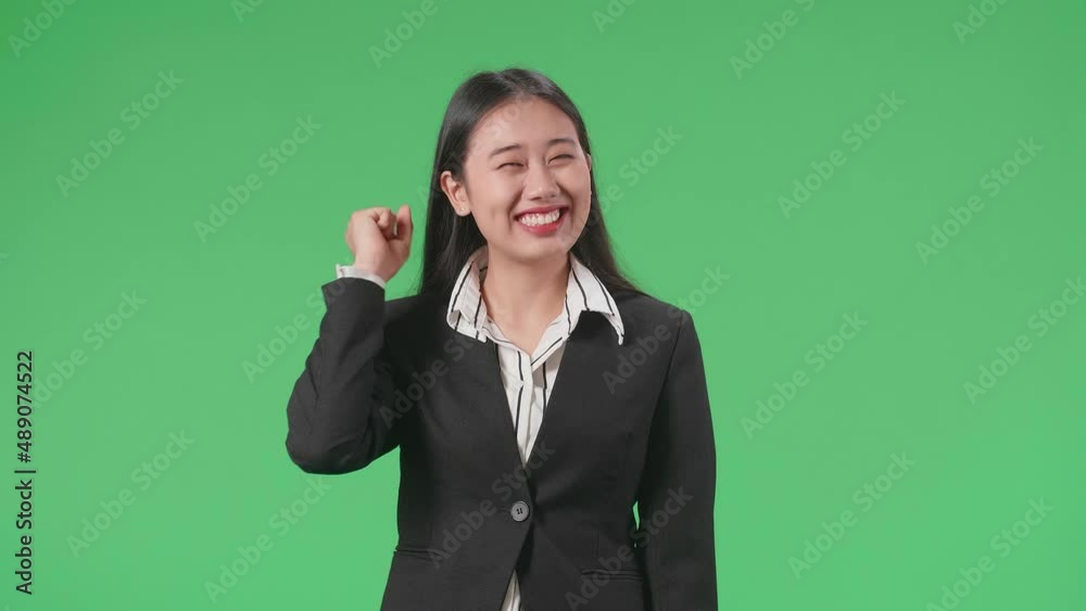 Happy Asian Business Woman Celebrating While Standing On Green Screen In The Studio
Happy Asian Business Woman Celebrating While Standing On Green Screen In The Studio