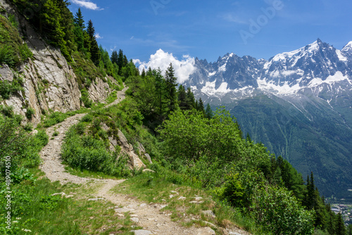 Mountain hiking trail in the Alps with a view of the Mont Blanc massif.