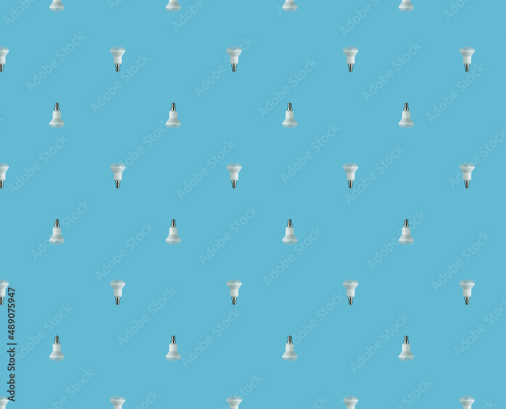 energy saving concept. seamless pattern of led lamps on a blue background. energy saving concept. seamless pattern of led lamps on a blue background.