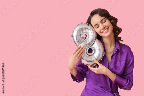 Smiling young woman with ba...